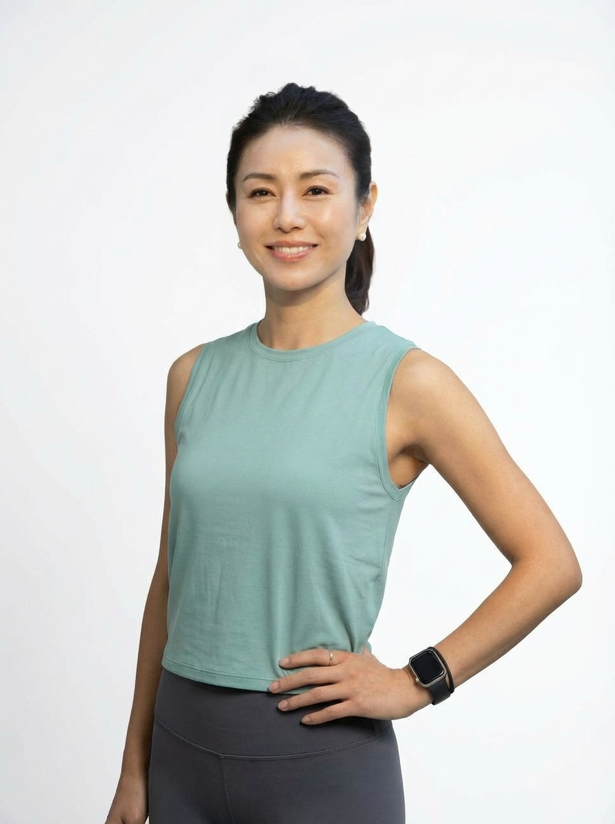 A_woman_wearing_a_sleeveless_top_in_muted_mint_co-1765497255519